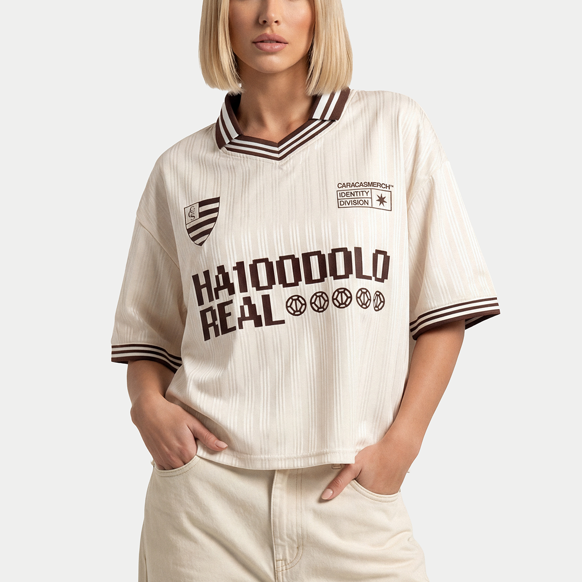 Woman wearing the Ha100dolo Real cream soccer jersey by Caracas Merch